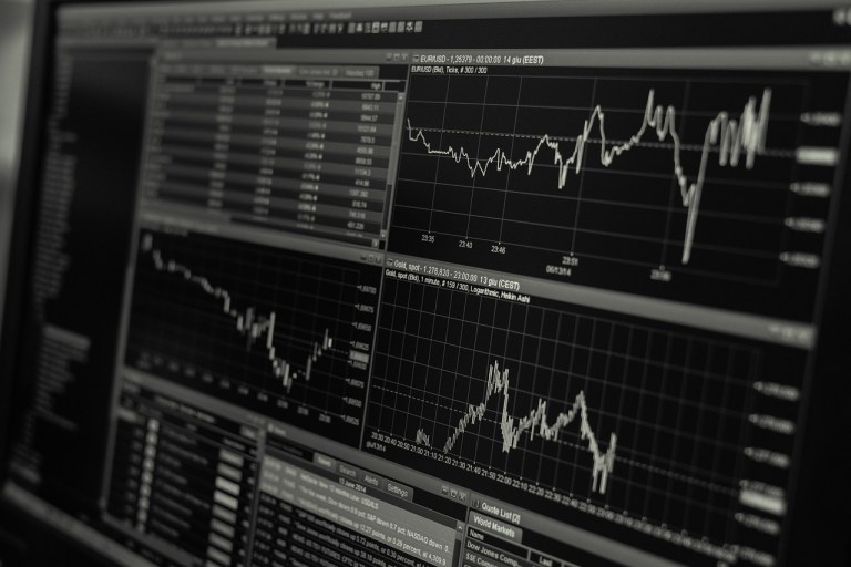 Financial trading screens illustrating market analysis for a token listing on a Korean exchange